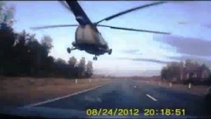 Russian Military Helicopter Flies Low Over Civilian Road